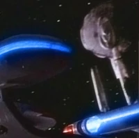 The Enterprise-D flies by the wrecked Princeton.