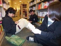 more active readers sitting between the shelves