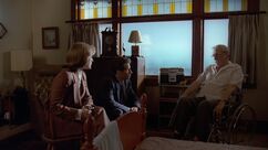 Dana Scully and Fox Mulder sit with Frank Briggs