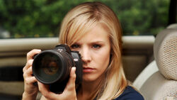 A promotional photo of Veronica Mars doing some surveillance.