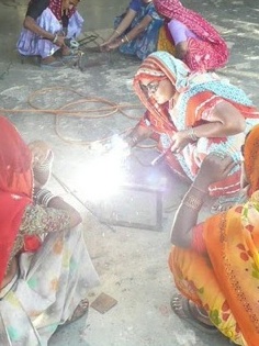 Barefoot College women students welding new Scheffler reflectors, 5-11