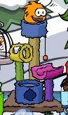 Orange puffle playing on a furniture