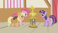 Applejack and Pinkie gazing at the trophy S1E04