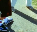 Why does John draw on the ground with his shoes and spin around?