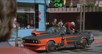 Griff's BMW being waxed by his grandfather, Biff Tannen.