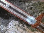 The DeLorean crosses the ravine on the completed bridge.