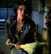 Jeannie defends herself with a broom