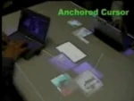 A mixed reality interface allowing moving documents between computers, desk surface and wall screen