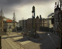 A City 17 plaza, under surveillance by Civil Protection units and equipment, with a "Breencast" monitor, which Doctor Breen uses to address City 17 citizens.