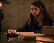 Ginny writing in Tom Riddle's diary.
