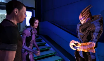 A turian C-Sec officer assists two members of the public