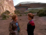 Amelia Earhart and Janeway, with Voyager landed behind