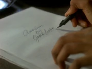 Jake Sisko signing the first page of Anslem, and the cover of the book from an alternate future