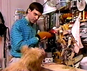 Tom Newby demonstrates a Waldo-controlled puppet to Jojo.