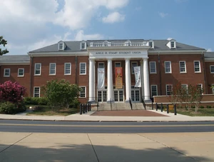 The statue is located behind the pink tree on the left of the Adele H. Stamp Student Union.