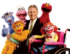 Gary Knell with an international selection of Muppets, in the 2006 Sesame Workshop Annual Report.