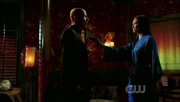 Lana points a gun at Lex.