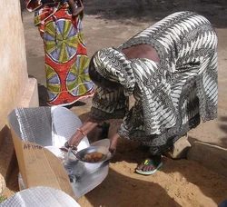 Mariam Toure proudly serves samples of her solar meal.